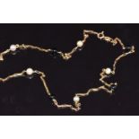 A 9ct gold necklace set with pearls and onyx, 2.5g