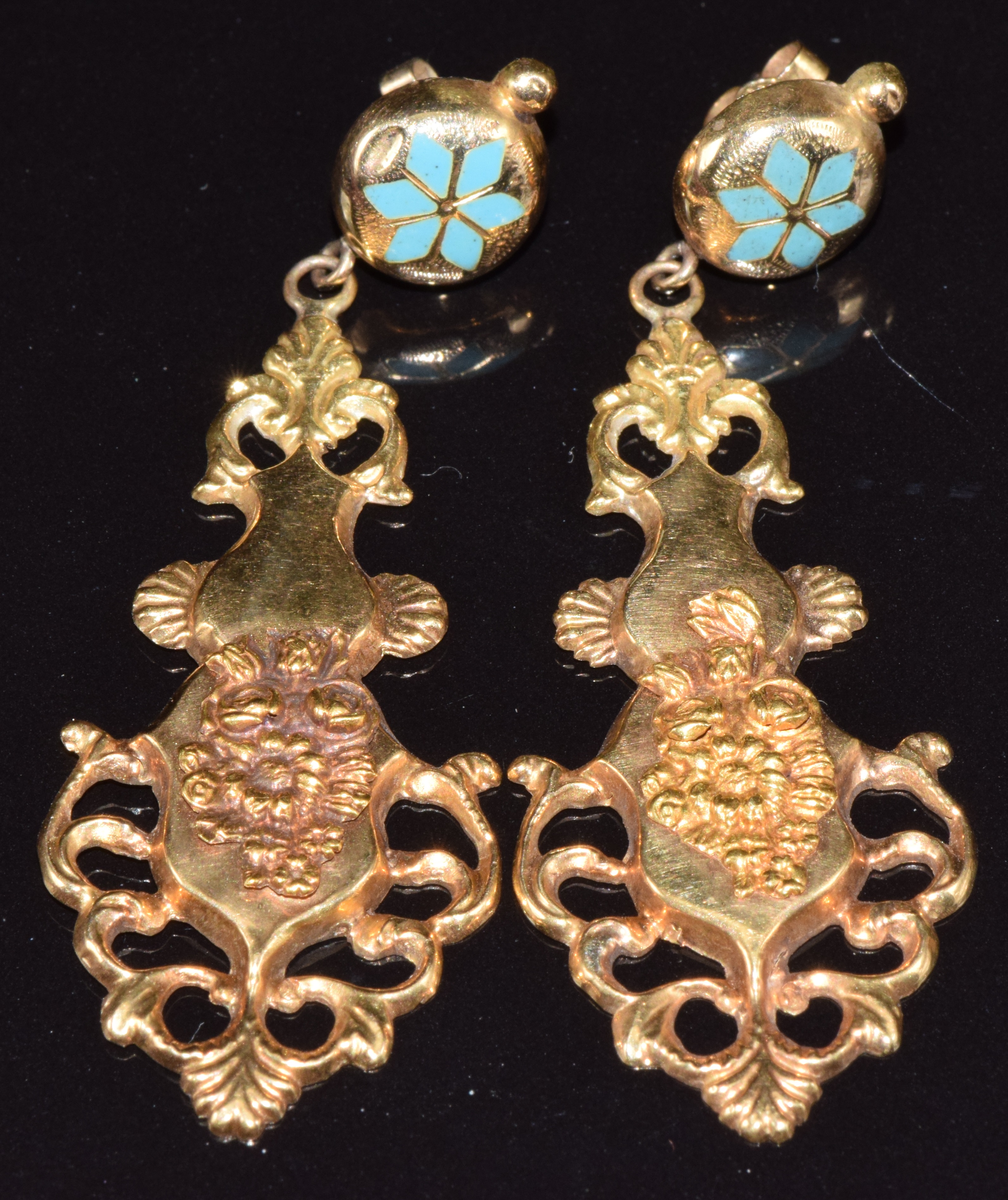 A pair of yellow metal earrings set with enamel and with embossed floral decoration, 4.6g