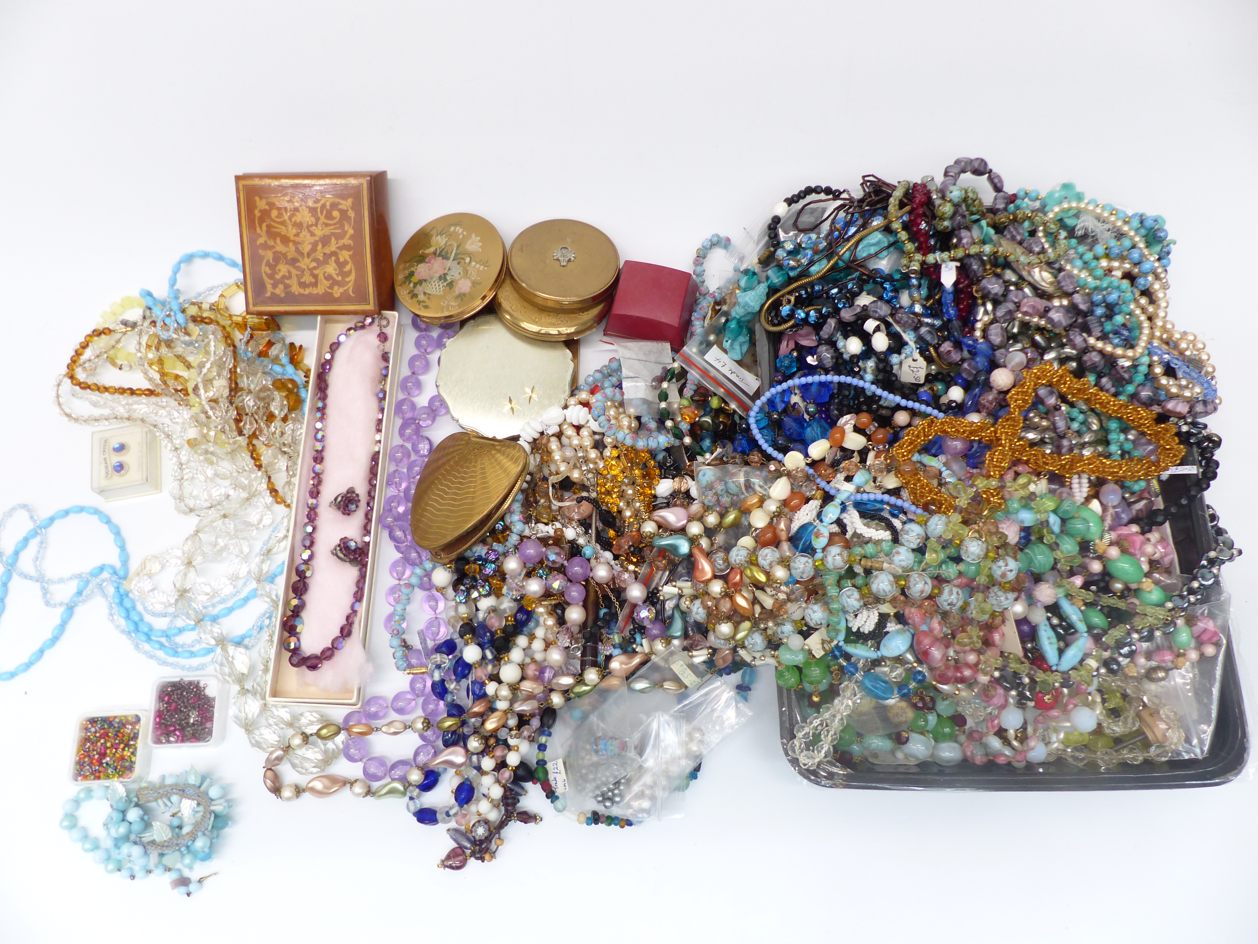 A collection of costume jewellery including vintage necklaces, beads, enamel buckle, enamel pot,