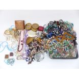 A collection of costume jewellery including vintage necklaces, beads, enamel buckle, enamel pot,