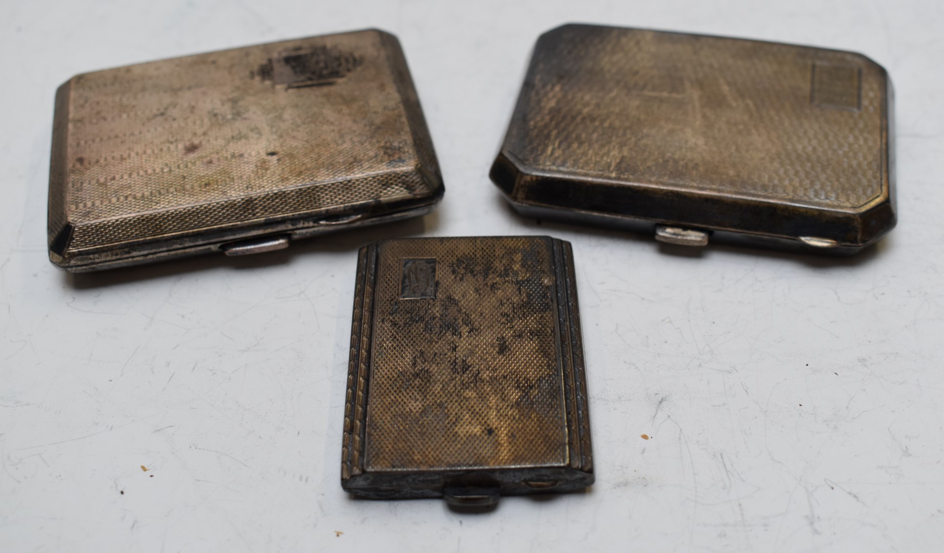 Three various hallmarked silver cigarette cases, all with engine turned decoration, length of