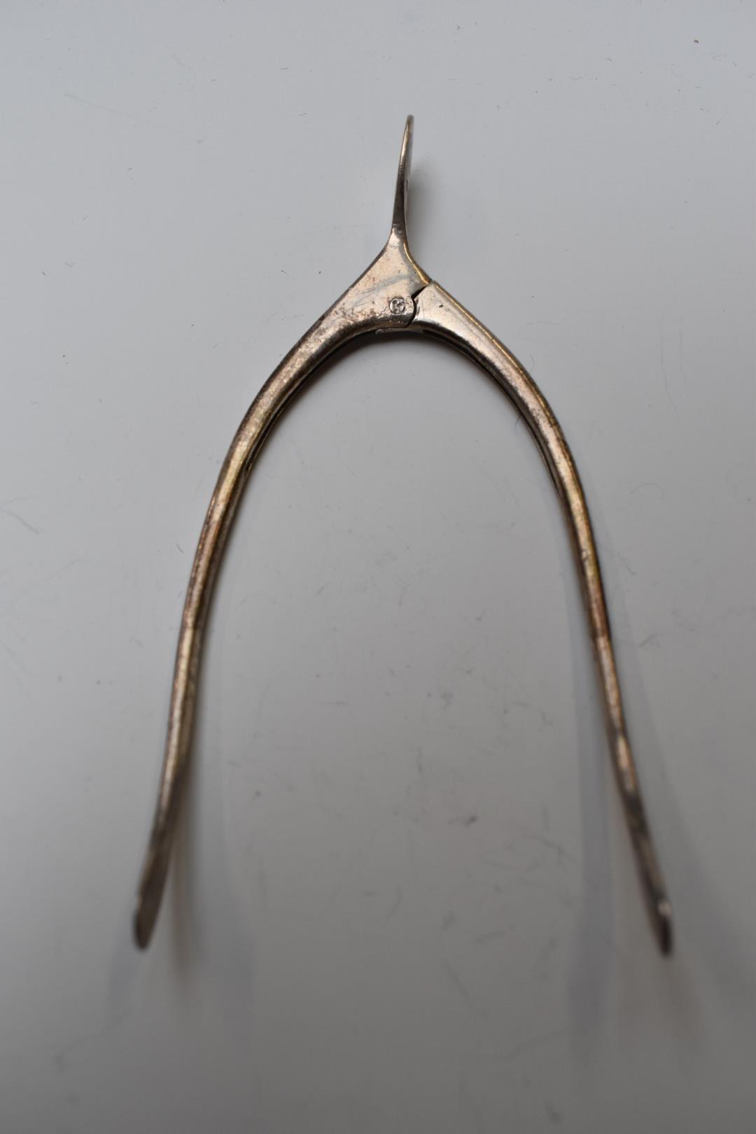 A pair of hallmarked silver novelty sugar nips in the form of wishbone, Birmingham 1918, maker