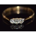 An 18ct gold ring set with three diamonds, 1.8g, size Q/R