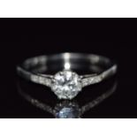 An 18ct white gold ring set with a round cut diamond of approximately 0.6ct, 2.7g, size O