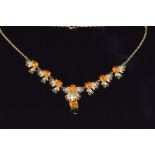 A 9ct gold necklace set with citrines and pearls in a stylised foliate design, 16.5g
