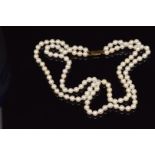 A double strand cultured pearl necklace with a 9ct gold claps