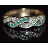 A 9ct gold ring set with emeralds and diamonds in a twist setting, 2.6g, size P