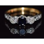 An 18ct gold ring set with a sapphire and diamonds in a platinum setting, 3.5g, size L/M