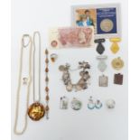 A collection of jewellery including silver bracelet and ring set with pressed amber, silver charm