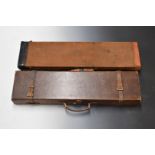 Two vintage canvas and leather bound gun cases, both with fitted interiors, largest 83x21x8cm.