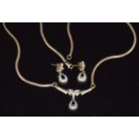 A 9ct gold necklace set with black diamonds and diamonds with matching earrings, 7.3g