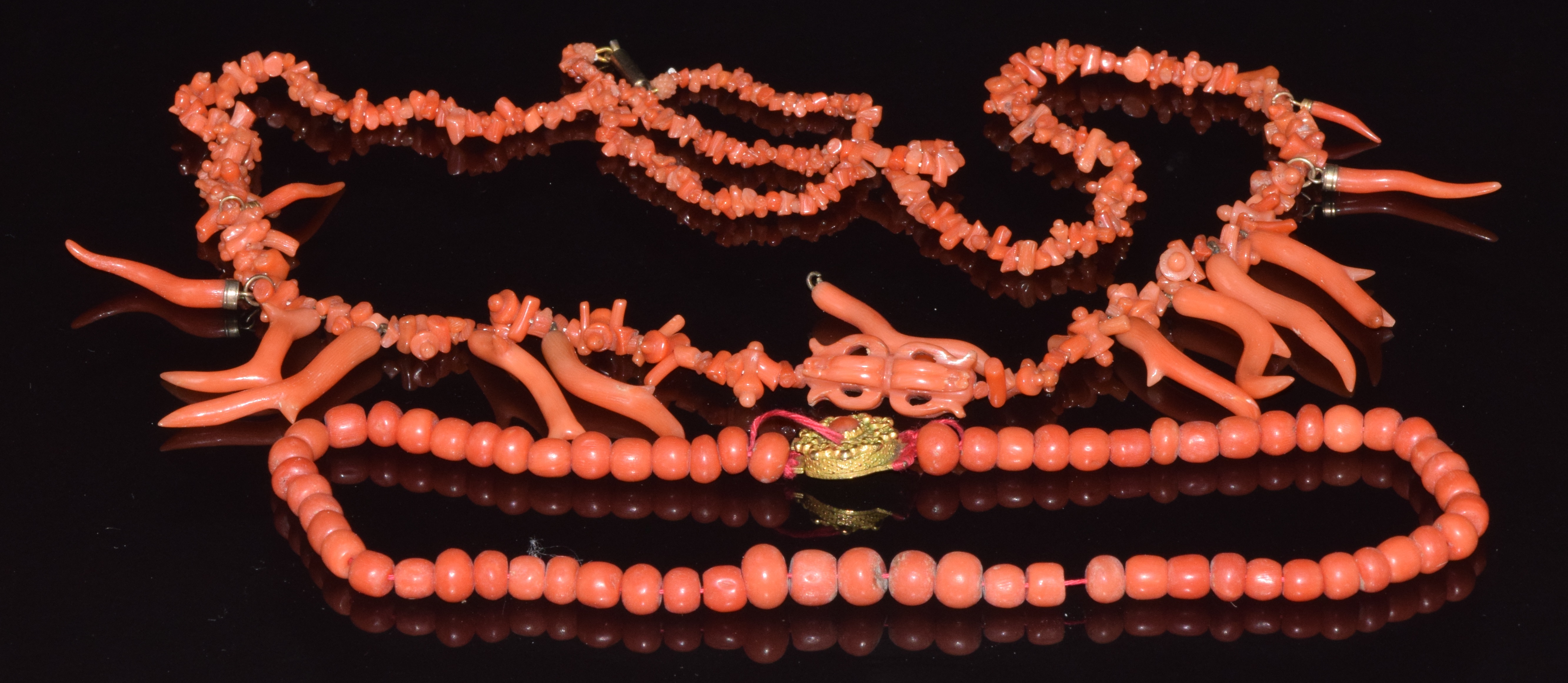Two coral necklaces, one with a carved section and natural drops, 60g