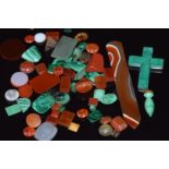 A collection of loose malachite and carnelian agate cabochons and plaques