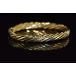 A 9ct gold bangle with ridged decoration, 18.5g