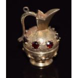 A 9ct gold charm/ pendant in the form of a ewer/ vase set with garnets, 7.5g