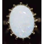 A 9ct gold ring set with an oval cut white opal, 4.5g, size O