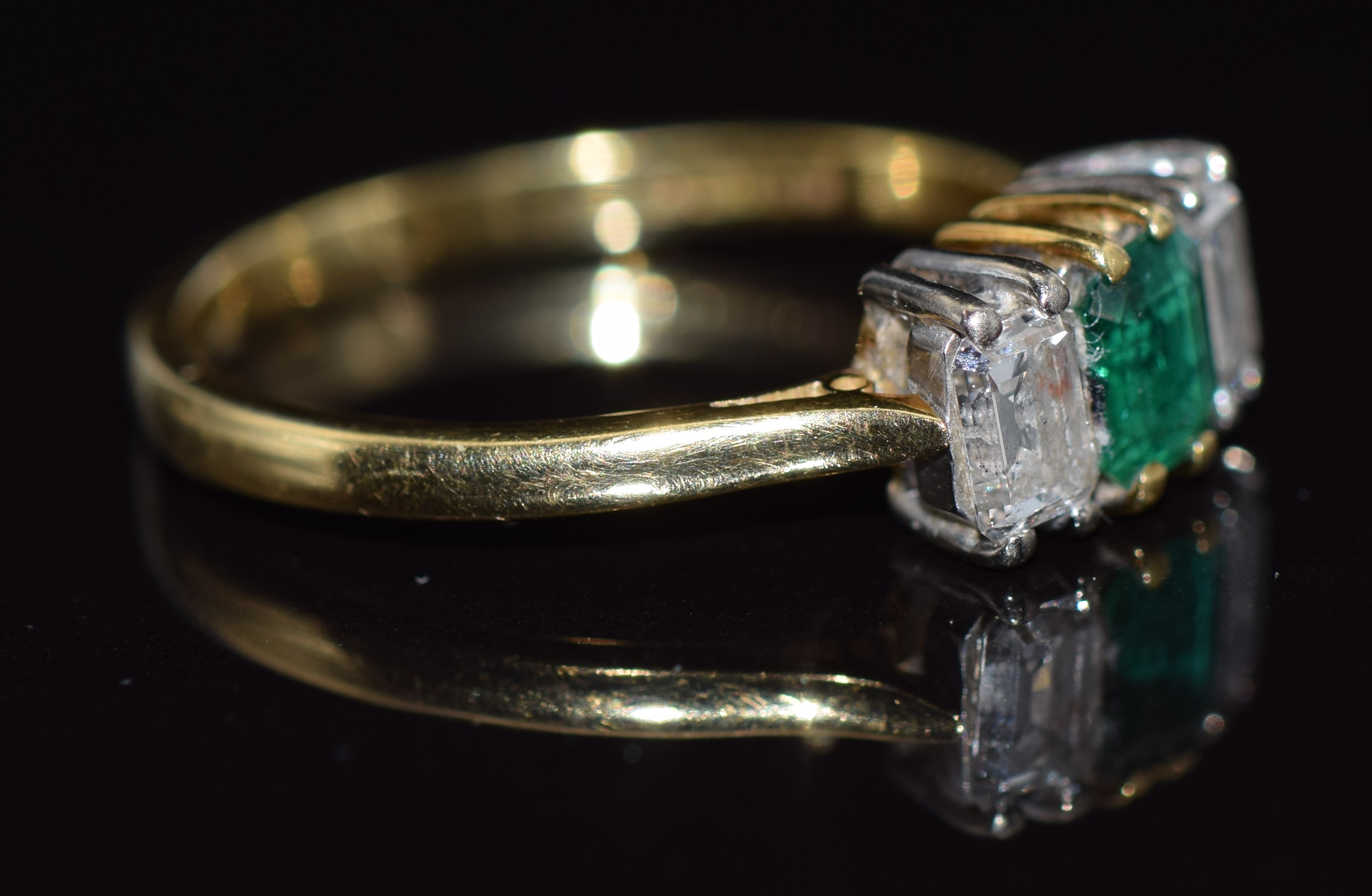 An 18ct gold ring set with an emerald cut emerald and two emerald cut diamonds, approximate - Image 2 of 2