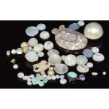 A collection of loose mother of pearl and loose opal cabochons