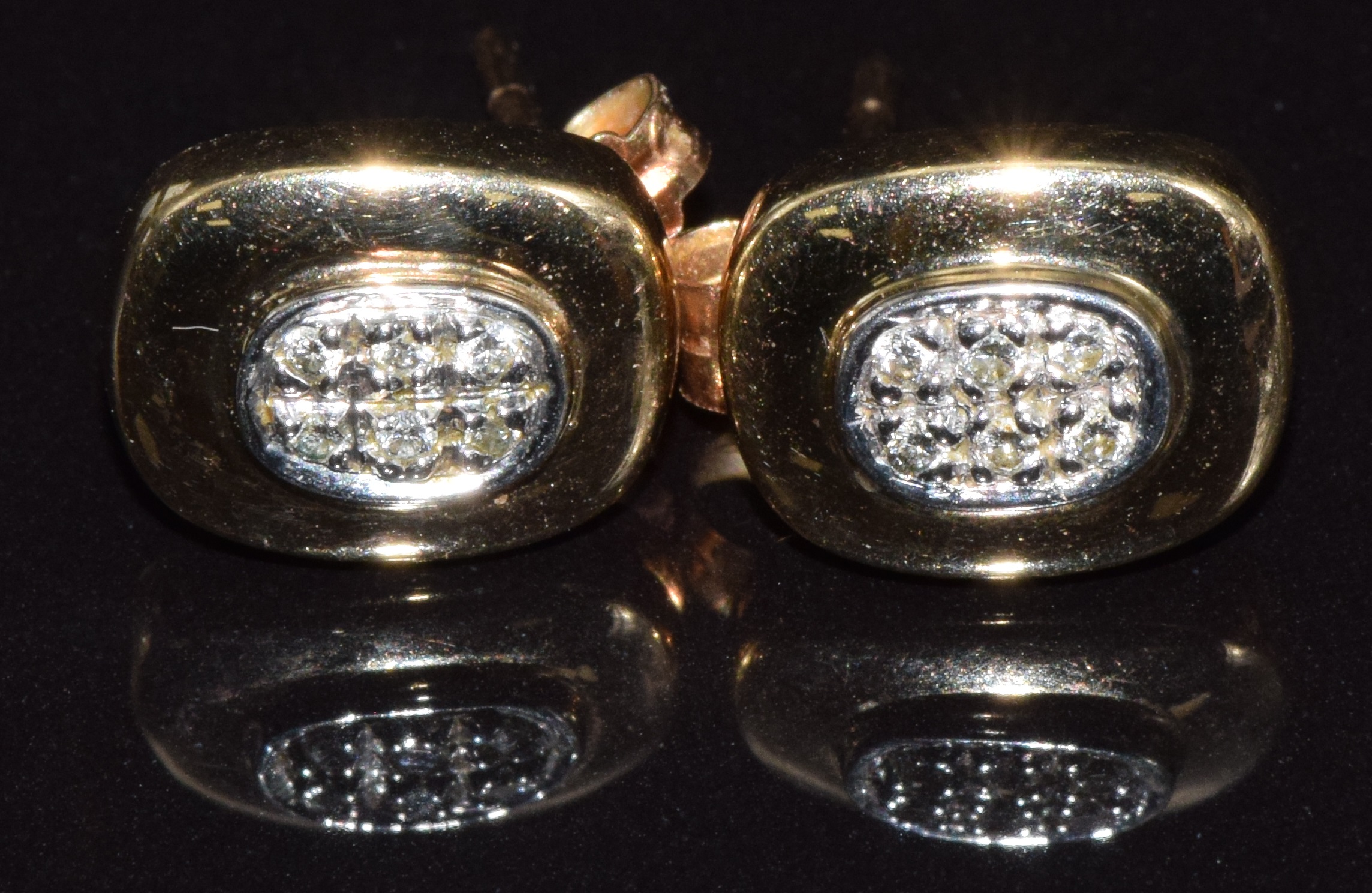 A pair of 9ct gold earrings set with diamonds, 2.1g