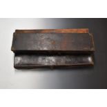 Three vintage leather bound shotgun cases, including one with Army & Navy label and one with