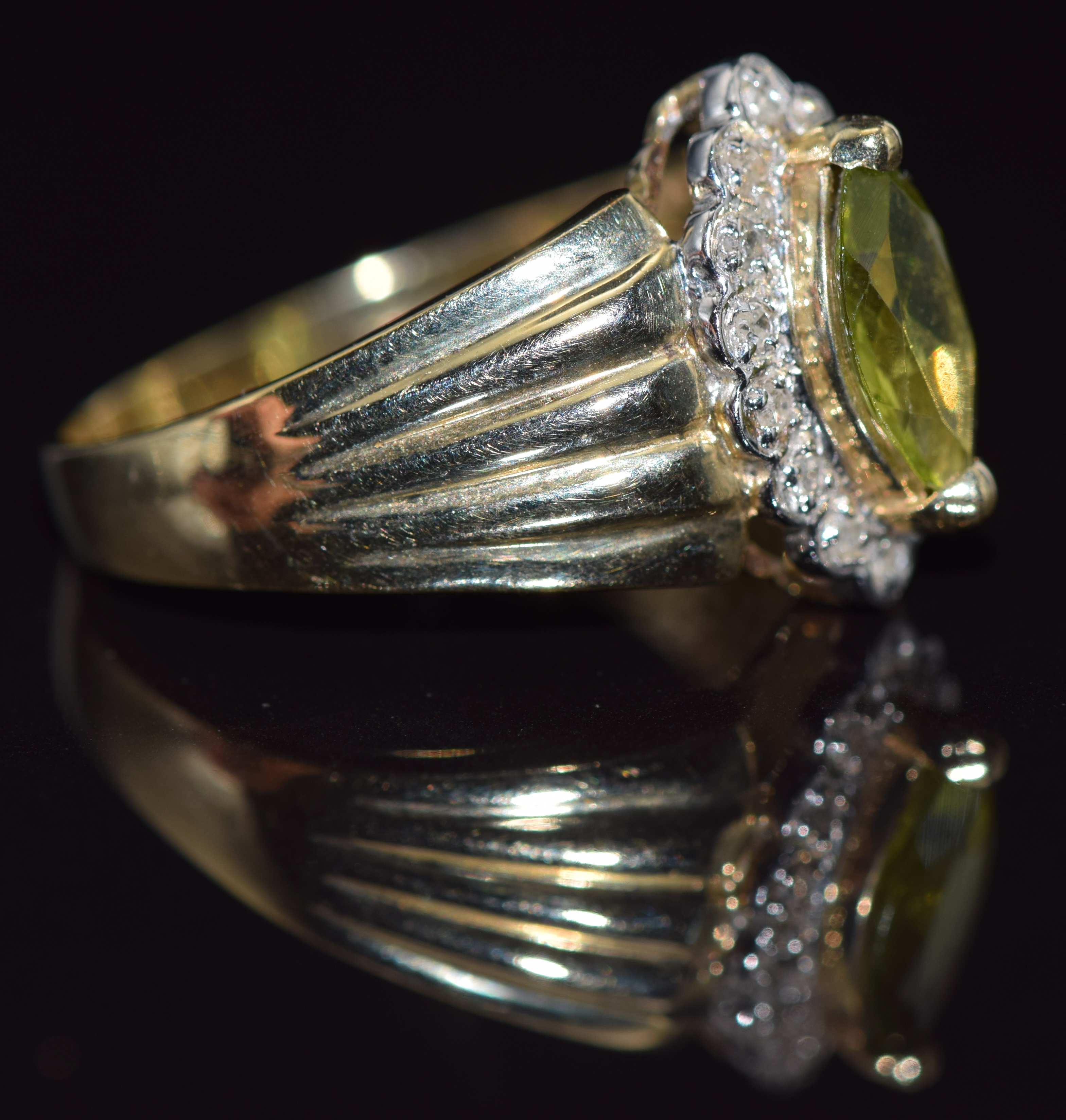 A 9ct gold ring set with a marquise cut peridot surrounded by diamonds, 4.0g, size R - Image 2 of 2