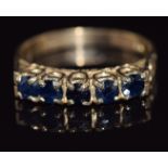 A 9ct gold ring set with five round cut sapphires, 2.4g, size M/N