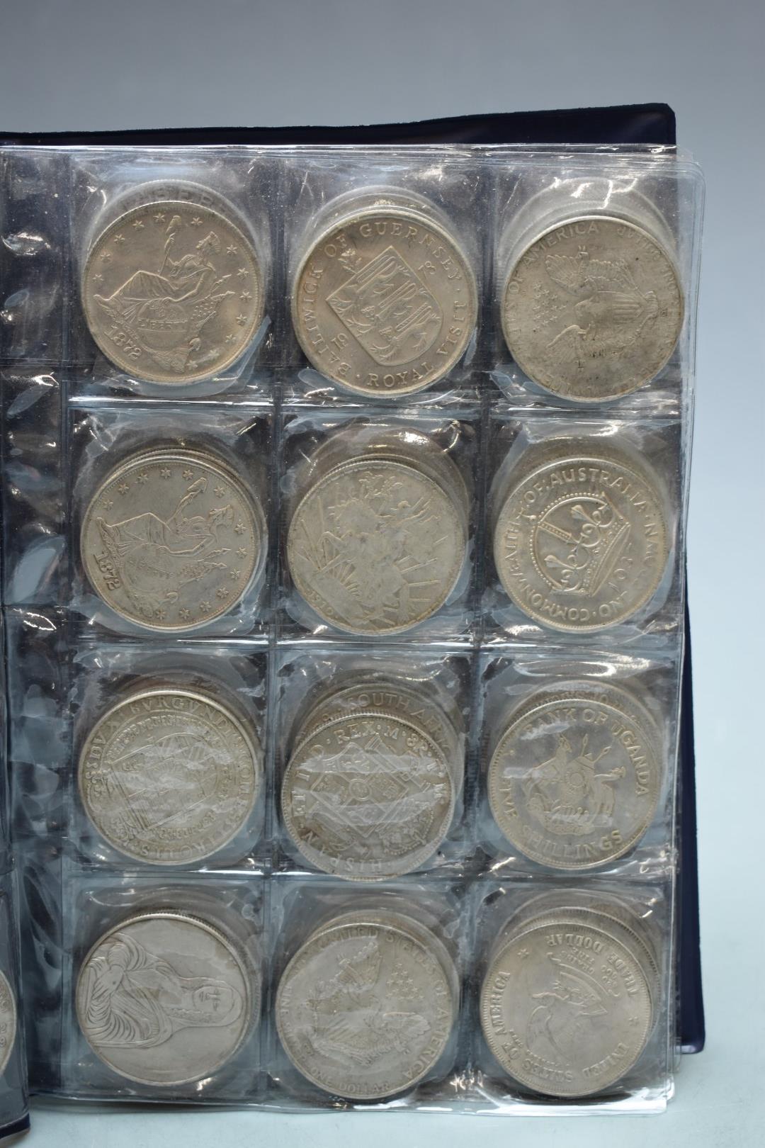 A collector's album of 720 replica dollar/crown sized silver coloured coins