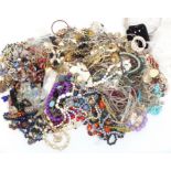 A collection of costume jewellery including vintage brooches, beads, necklaces, etc