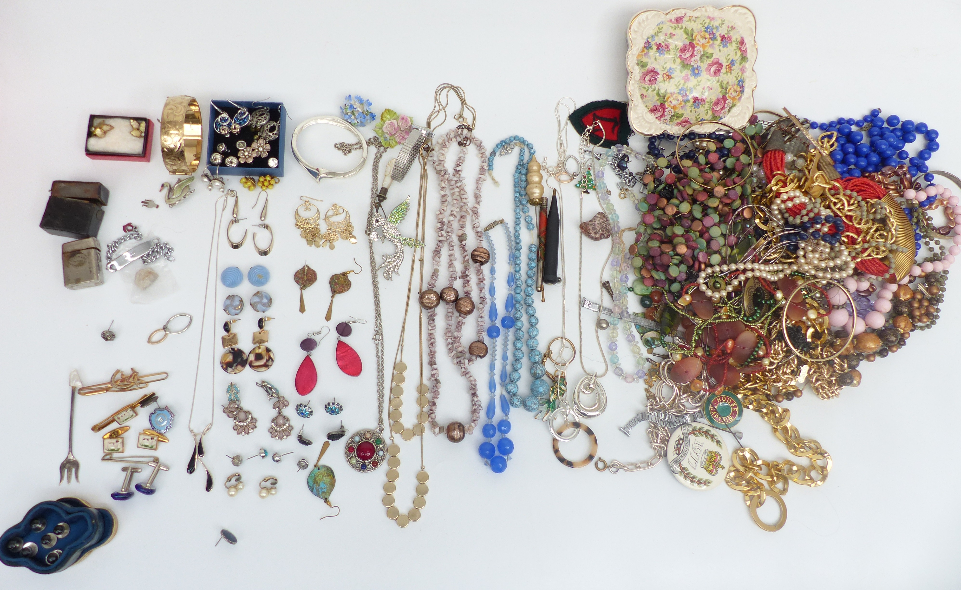 A collection of costume jewellery including necklaces, enamel and marcasite brooch, earrings, rolled