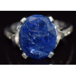 An 18k white gold ring set with a sapphire and diamonds to the shoulders and mount, 8.3g, size K/L