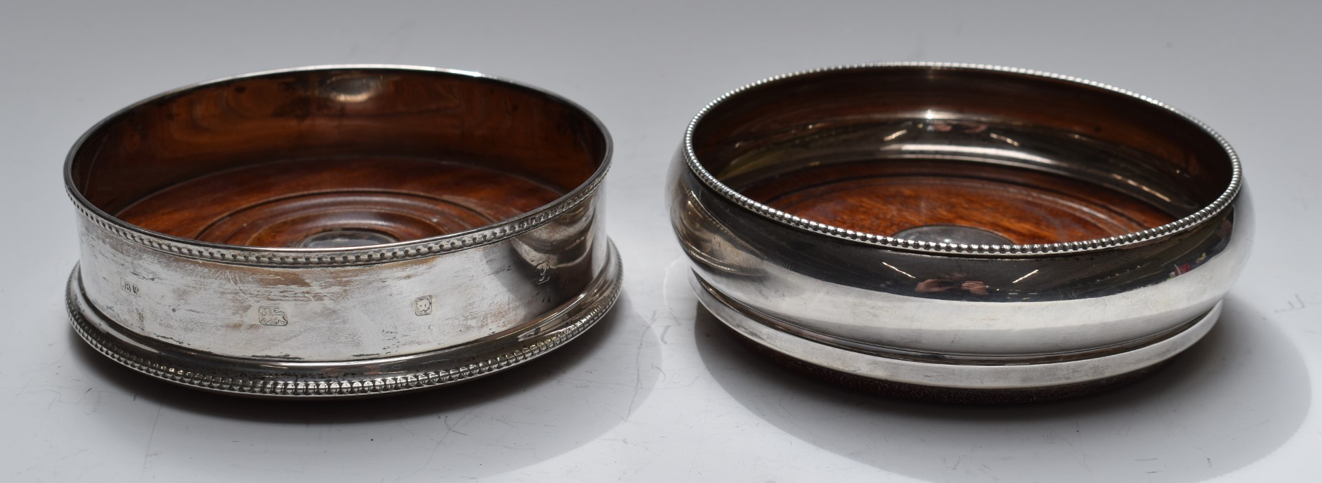 Two hallmarked silver wine coasters, one with feature hallmarks, diameter of largest 14cm