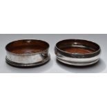 Two hallmarked silver wine coasters, one with feature hallmarks, diameter of largest 14cm