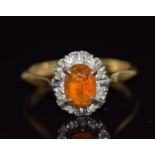 An 18ct gold ring set with an oval cut citrine and diamonds, 3.2g, size L