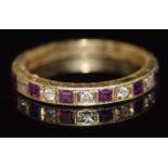 An 18ct gold half eternity ring set with rubies and diamond, 2.6g, size L/M
