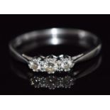 An 18ct white gold ring set with three diamonds, total diamond weight approximately 0.25ct, 2.6g,