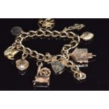 A 9ct gold charm bracelet with eight 9ct gold charms including a moving cuckoo clock, etc, 25.3g