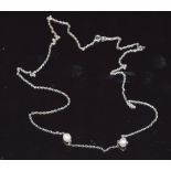 A 9ct white gold necklace set with two pearls, 3.3g