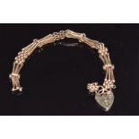 A 9ct rose gold gate bracelet with heart padlock, 10.9g
