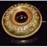 Victorian Etruscan Revival brooch set with a garnet cabochon, 3.2cm, 7.7g