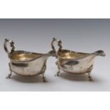 Large pair of George V hallmarked silver gravy or sauce boats with S scroll handles and gadrooned