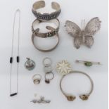 Silver jewellery including three bangles, filigree brooch and four rings, St George and the dragon