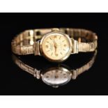 Accurist 9ct gold ladies wristwatch with gold hands, hour markers and Arabic numerals, champagne
