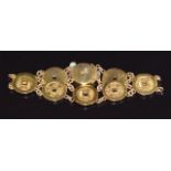 An 18ct gold Chinese bracelet made up of circular links with Chinese character decoration, 19.9g