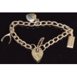 A 9ct gold charm bracelet with an ingot, wishbone and heart charm, 12g