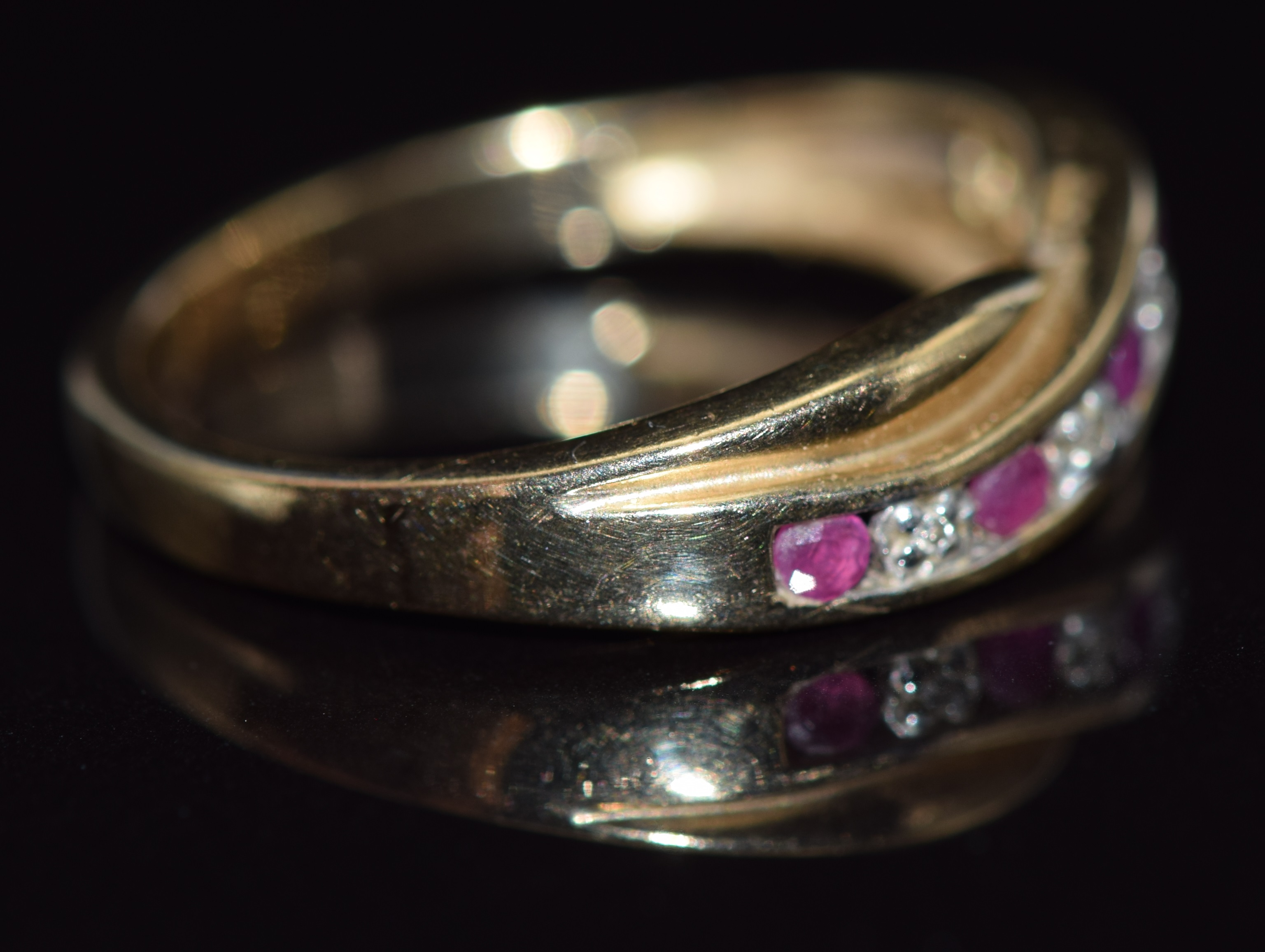 A 9ct gold ring set with diamonds and rubies in a twist setting, 2.8g, size O - Image 2 of 2