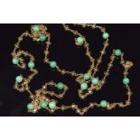 A gold necklace made up of floral links and jadeite beads, 35.6g, 140cm long