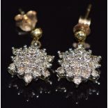 A pair of 9ct gold earrings set with diamonds in a cluster, 2.3g