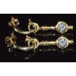 A pair of 14ct gold earrings set with diamonds of approximately 0.38ct & 0.3ct