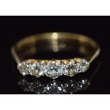An 18ct gold ring set with five diamonds, 2.1g, size J