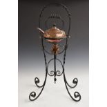 In the manner of W.A.S. Benson Arts and Crafts copper spirit kettle on wrought iron stand, H73cm
